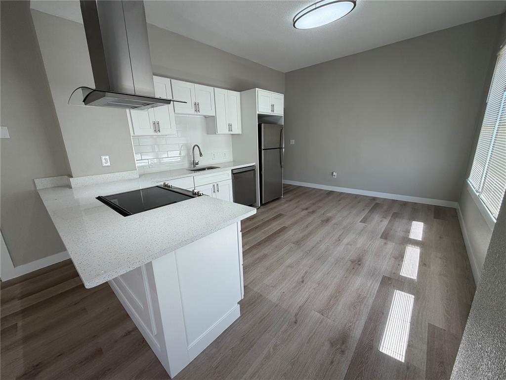 205 South 13th Street Palatka, FL 32177 - Photo 5 of 39 a kitchen with kitchen island a sink and a stove top oven