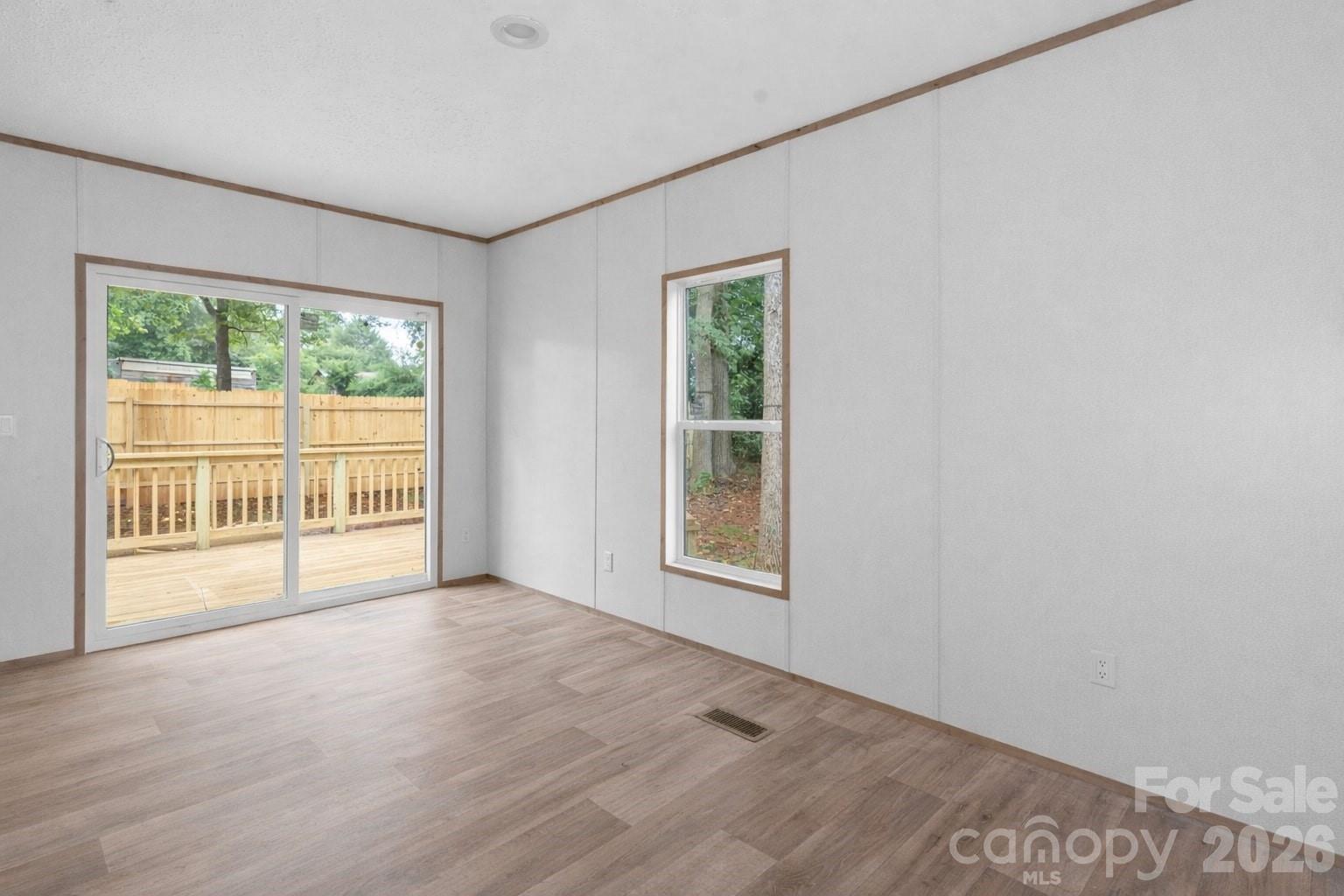 536 Lincolnview Road Lincolnton, NC 28092 - Photo 11 of 32 an empty room with wooden floor and windows