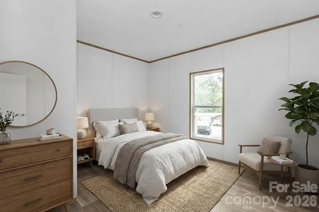 a bedroom with a bed and a mirror