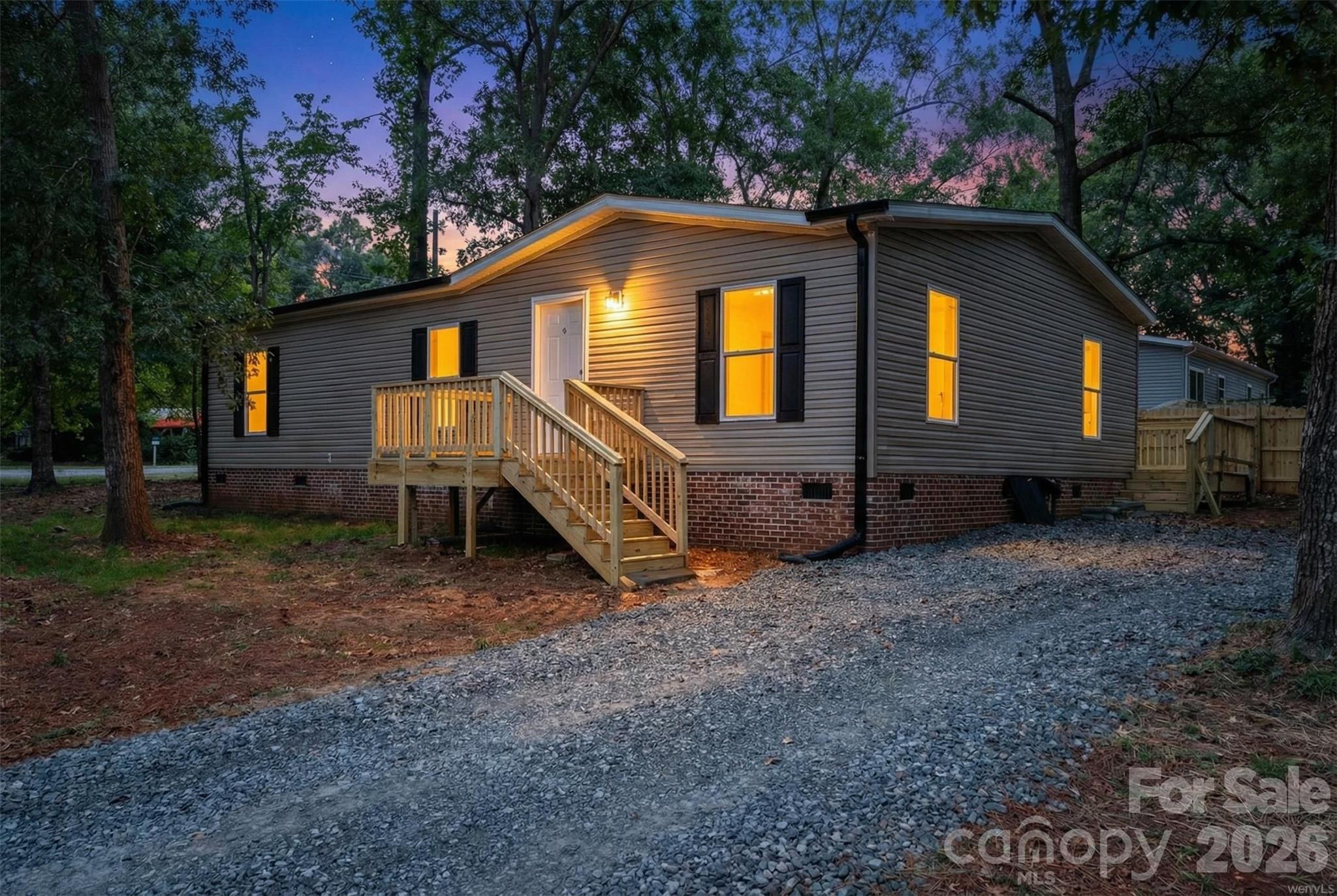 536 Lincolnview Road Lincolnton, NC 28092 - Photo 25 of 32 a backyard of a house with wooden fence and porch
