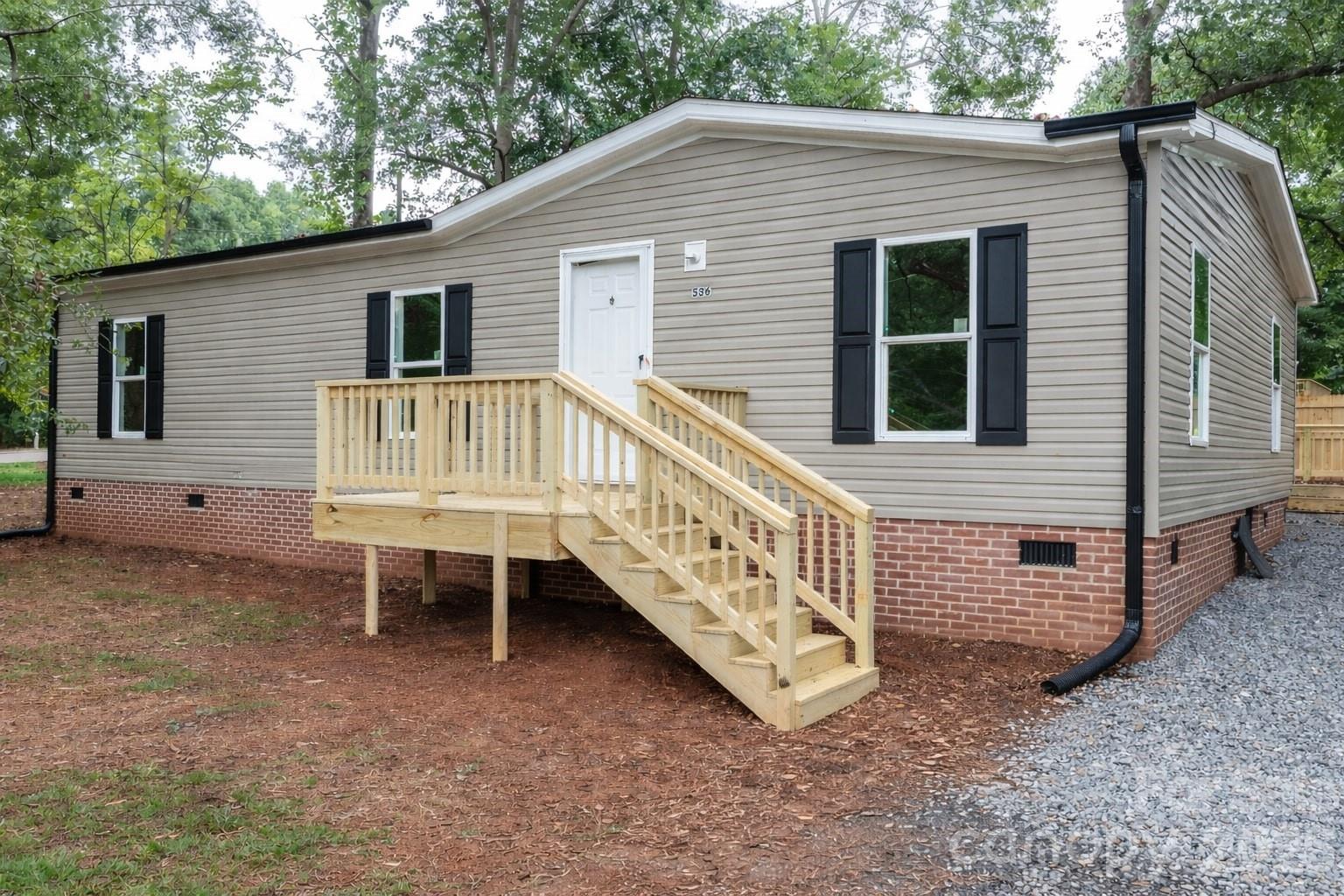 536 Lincolnview Road Lincolnton, NC 28092 - Photo 3 of 32 a view of a house with a yard and wooden fence