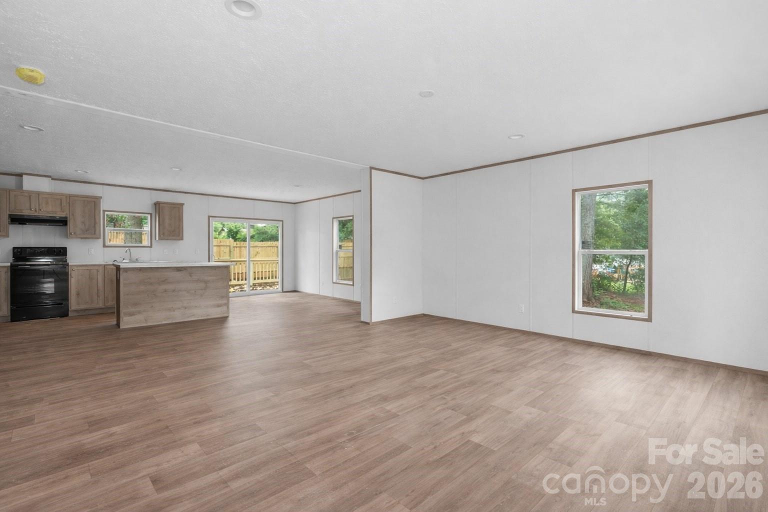 536 Lincolnview Road Lincolnton, NC 28092 - Photo 6 of 32 a view of an empty room with a window and wooden floor