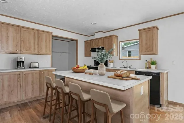 a view of a kitchen area with furniture and wooden floor