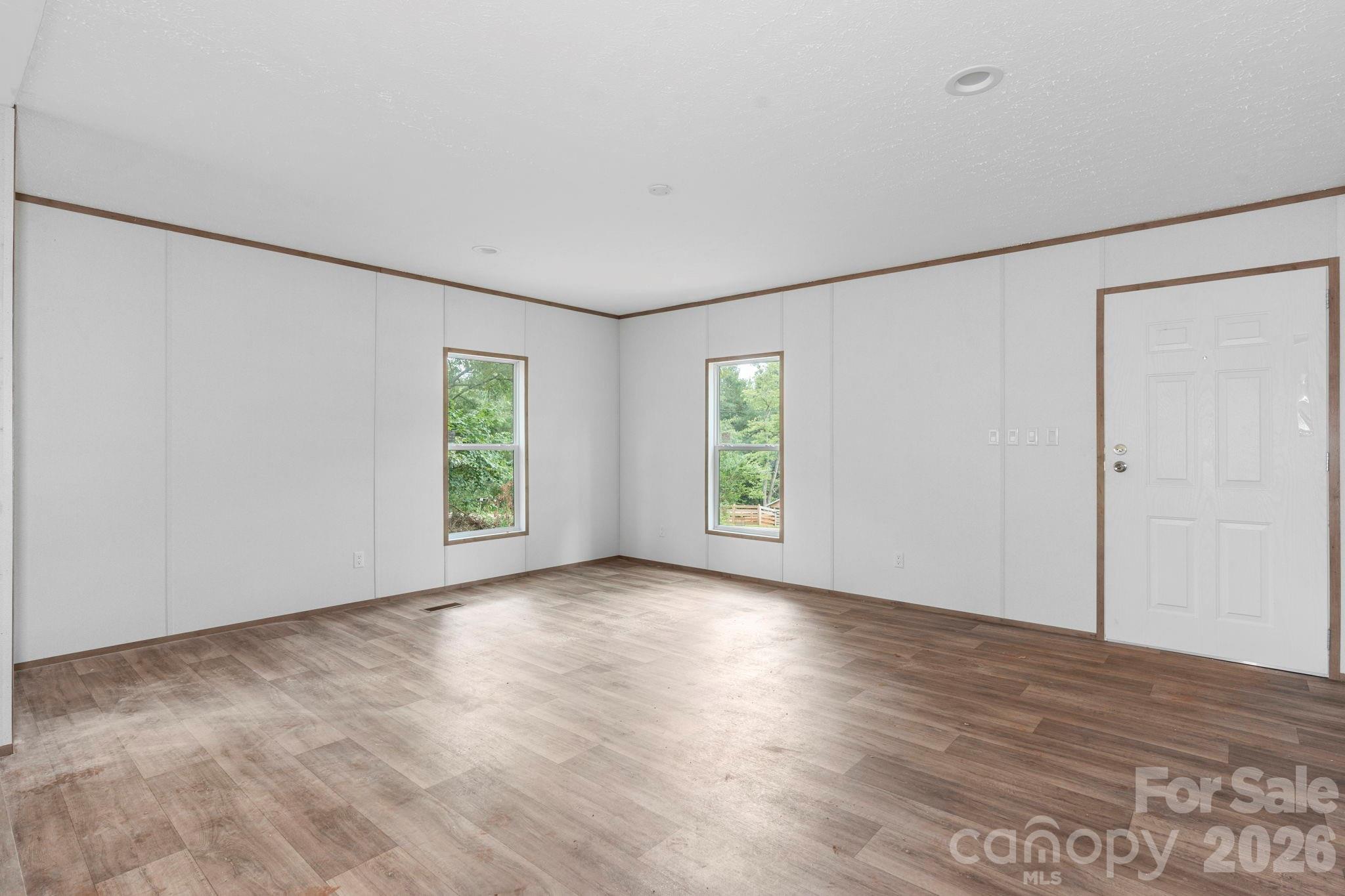 536 Lincolnview Road Lincolnton, NC 28092 - Photo 7 of 32 an empty room with wooden floor and windows