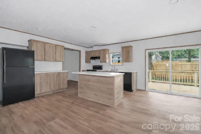 a kitchen with a sink stove and microwave