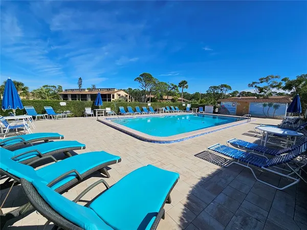 a view of a swimming pool with an outdoor seating