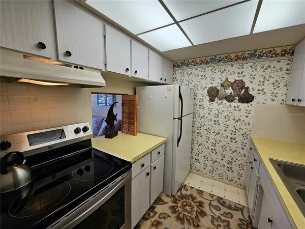 a kitchen with a stove and a refrigerator