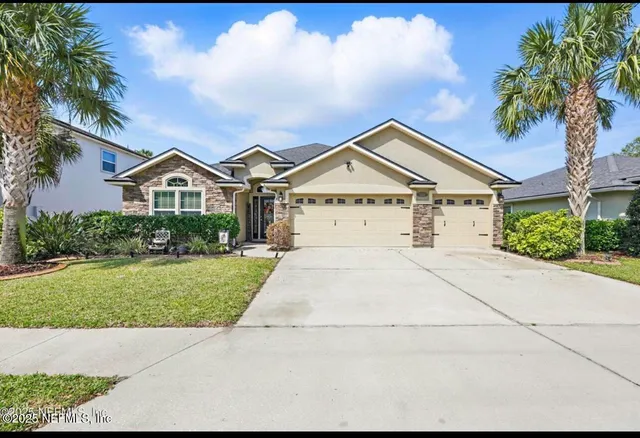 a front view of a house with a yard and garage