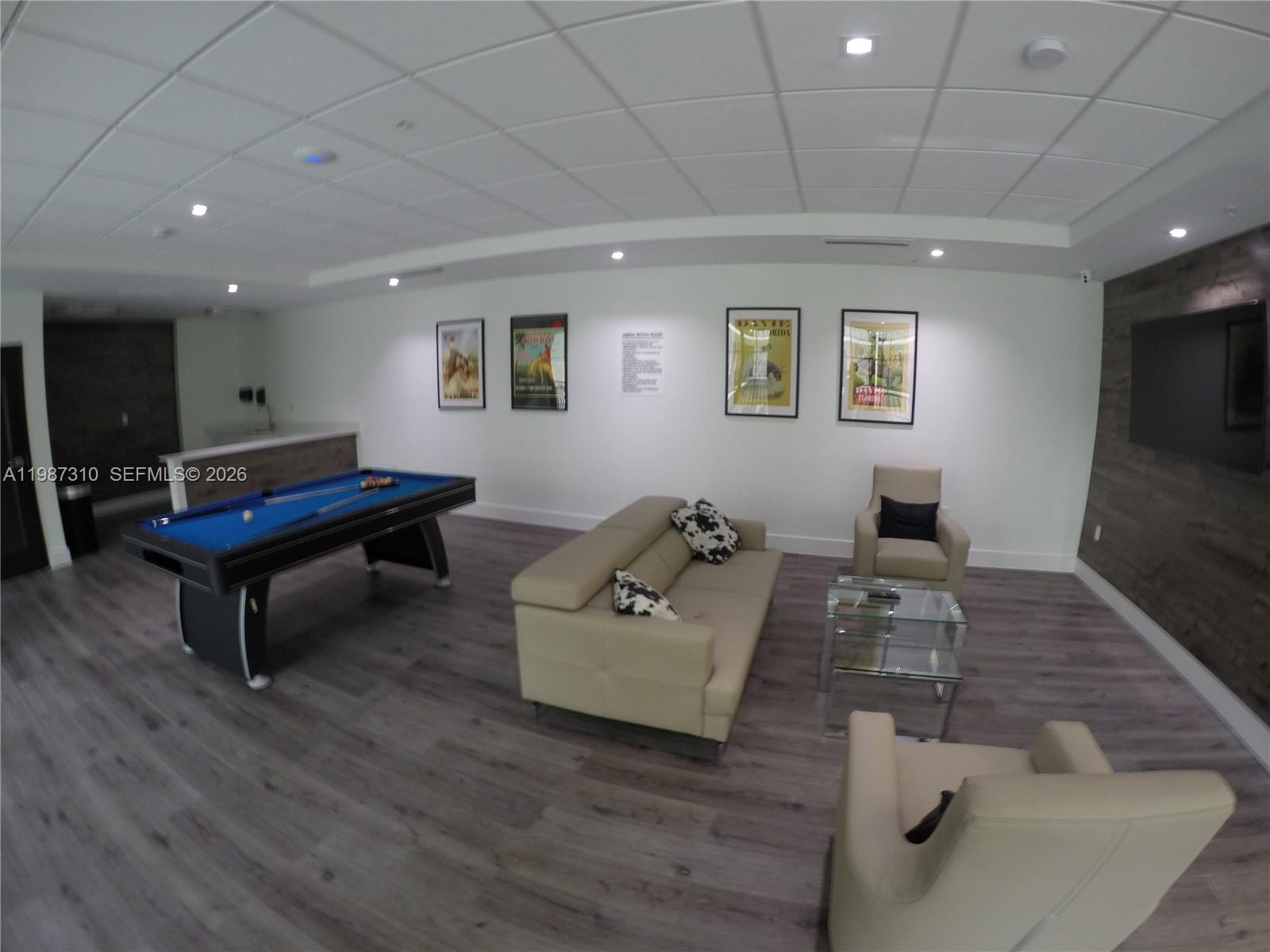 4100 Southwest 64th Avenue, Unit 409 Davie, FL 33314 - Photo 15 of 19 a living room with furniture and a wooden floor