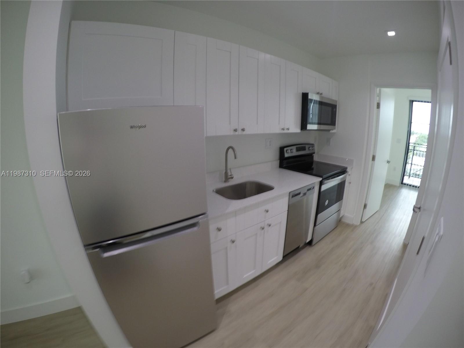 4100 Southwest 64th Avenue, Unit 409 Davie, FL 33314 - Photo 6 of 19 a kitchen with stainless steel appliances a refrigerator sink and microwave