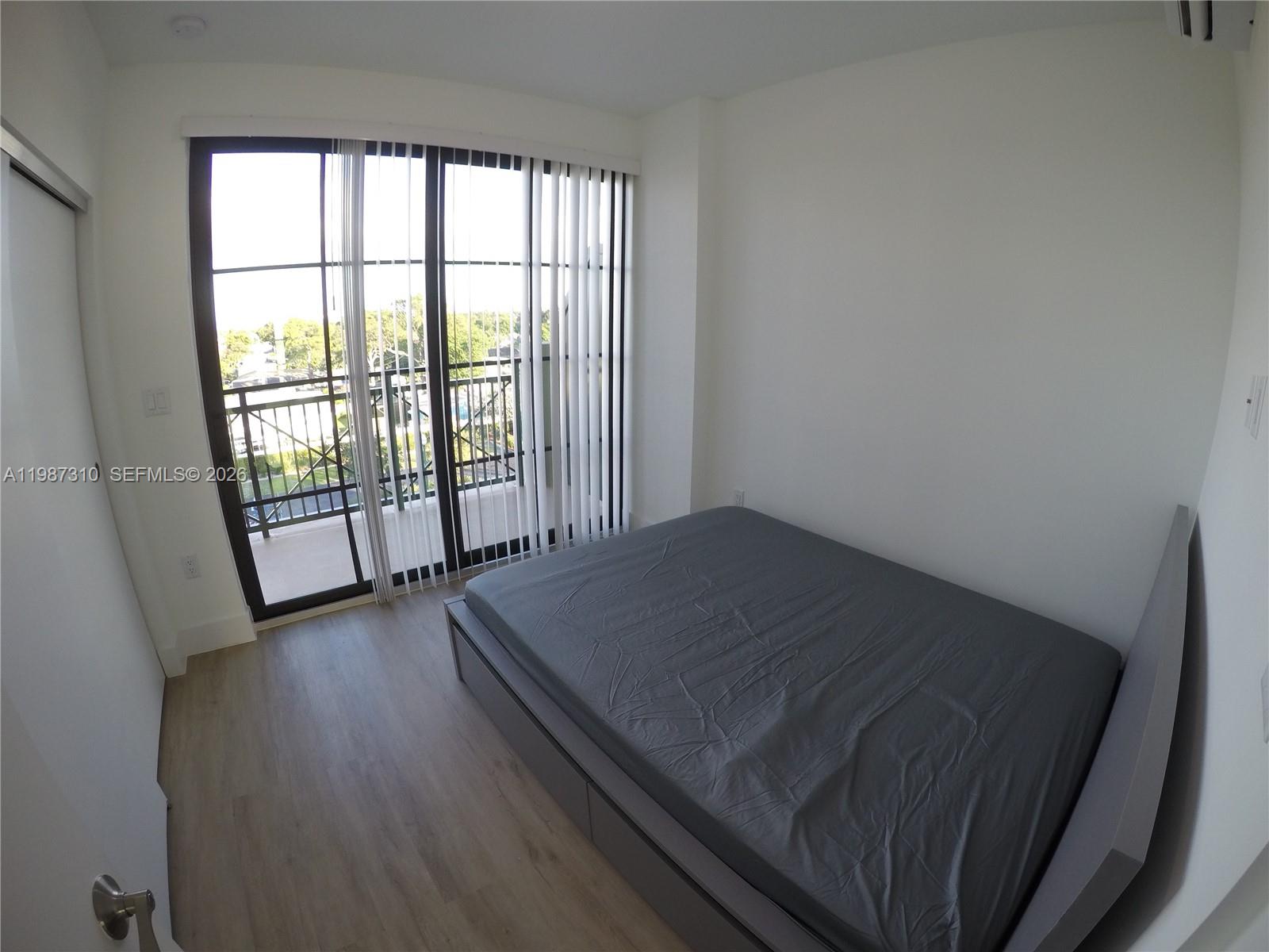 4100 Southwest 64th Avenue, Unit 409 Davie, FL 33314 - Photo 9 of 19 a bed sitting in a bedroom next to a window