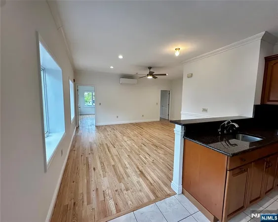 a kitchen with granite countertop a sink stove and cabinets