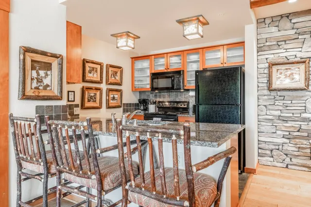 a kitchen with stainless steel appliances granite countertop a stove and a refrigerator