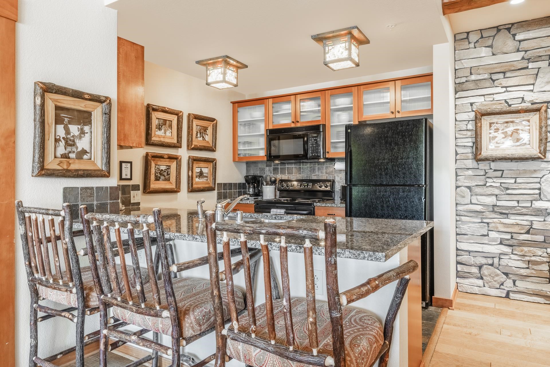6201 Minaret Road, Unit 2317 Mammoth Lakes, CA 93546 - Photo 13 of 44 a kitchen with stainless steel appliances granite countertop a stove and a refrigerator