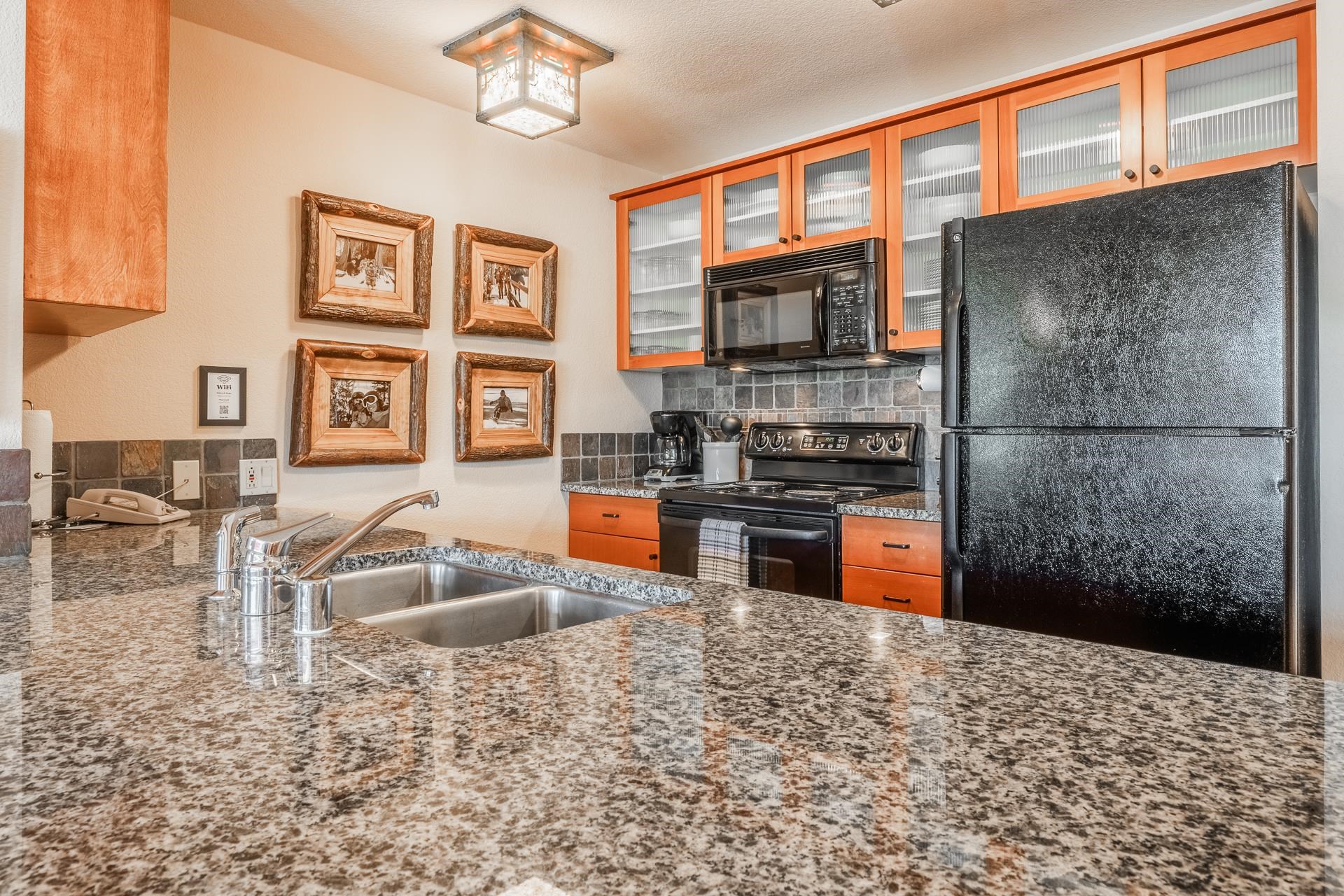 6201 Minaret Road, Unit 2317 Mammoth Lakes, CA 93546 - Photo 14 of 44 a kitchen view with granite countertop a stove and cabinets