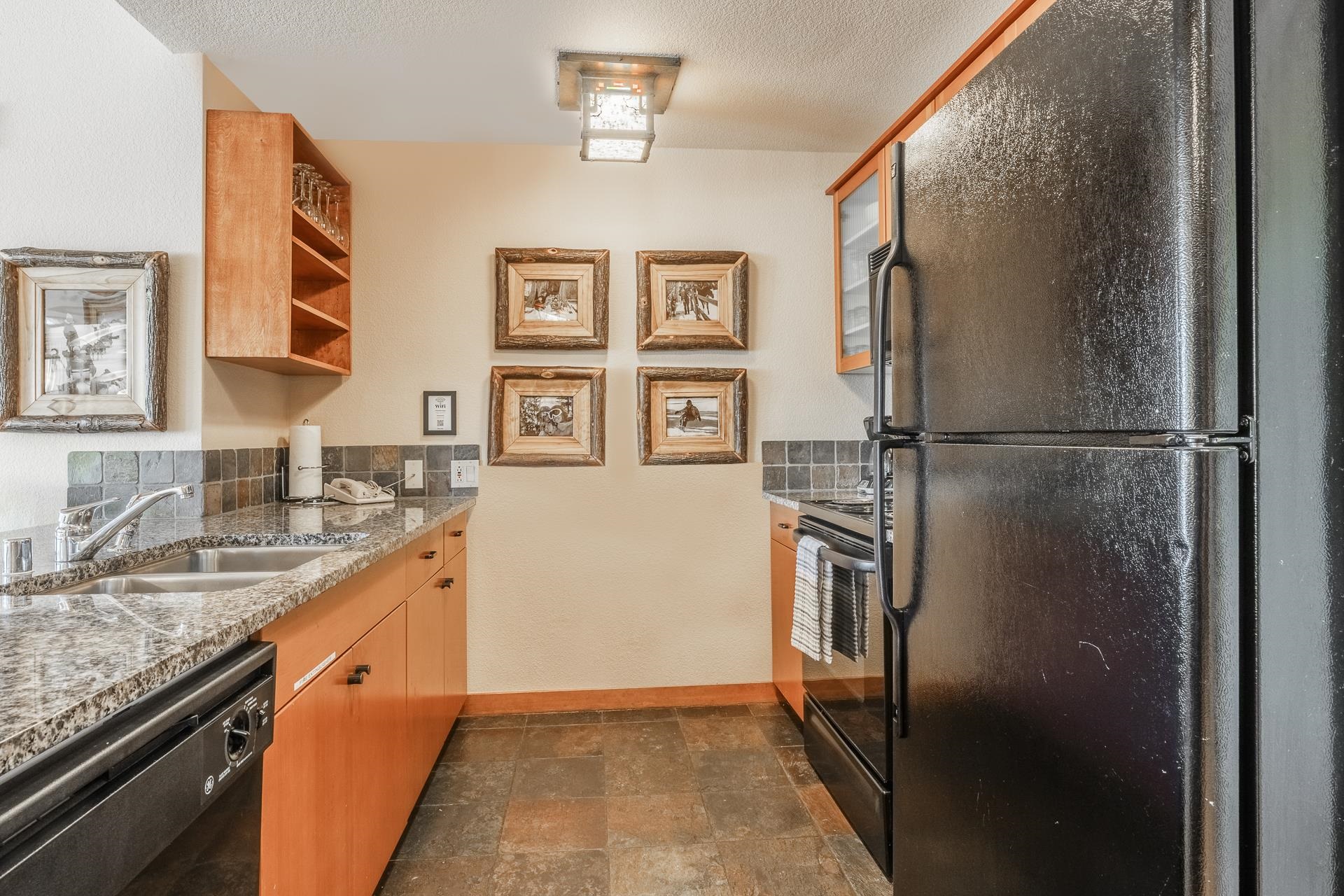 6201 Minaret Road, Unit 2317 Mammoth Lakes, CA 93546 - Photo 15 of 44 a kitchen with stainless steel appliances granite countertop a refrigerator and a sink