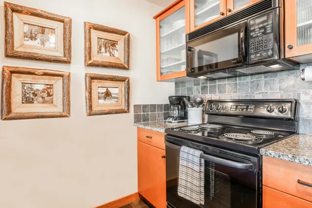 a kitchen with stainless steel appliances granite countertop a stove and a microwave