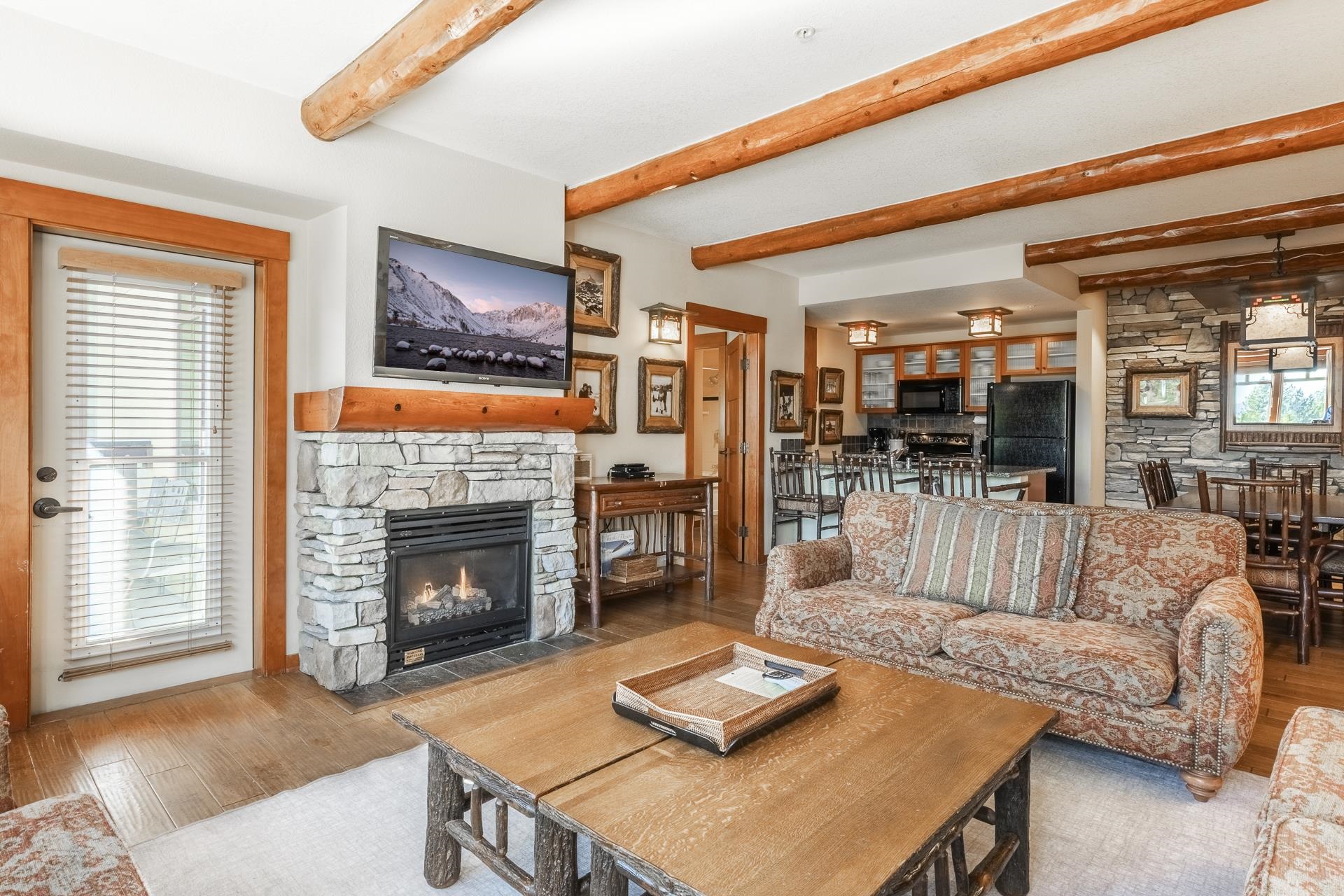 6201 Minaret Road, Unit 2317 Mammoth Lakes, CA 93546 - Photo 2 of 44 a living room with furniture and a fireplace