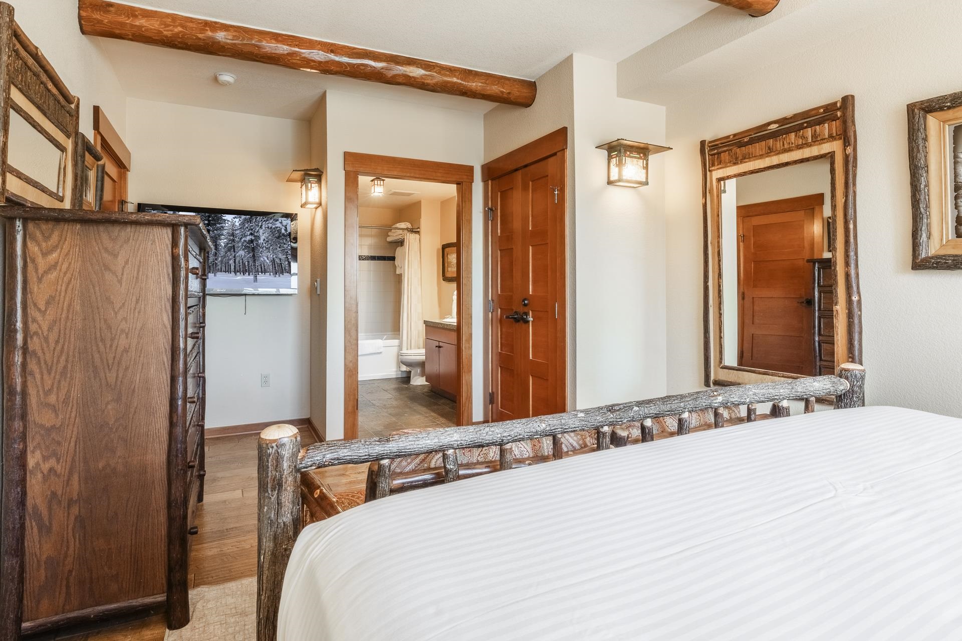 6201 Minaret Road, Unit 2317 Mammoth Lakes, CA 93546 - Photo 33 of 44 a bedroom with a bed a dresser and mirror