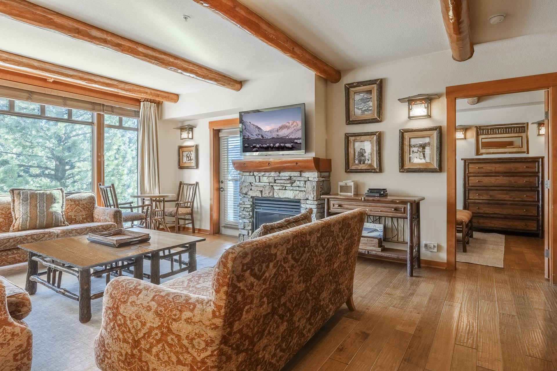 6201 Minaret Road, Unit 2317 Mammoth Lakes, CA 93546 - Photo 4 of 44 a living room with furniture and a floor to ceiling window