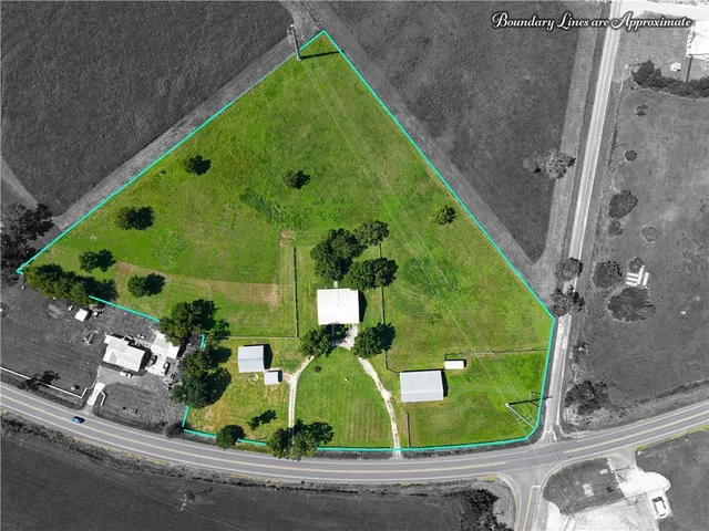 a view of a big yard with a house in the background