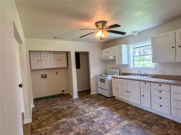 a kitchen with a stove a sink and a refrigerator