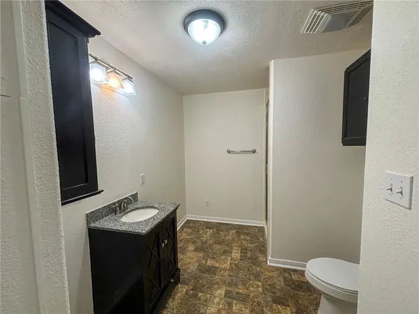 a yellow house with a big yard and a large trees with a small yard