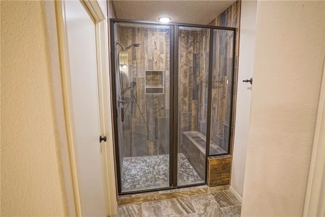 a bathroom with a shower and a sink