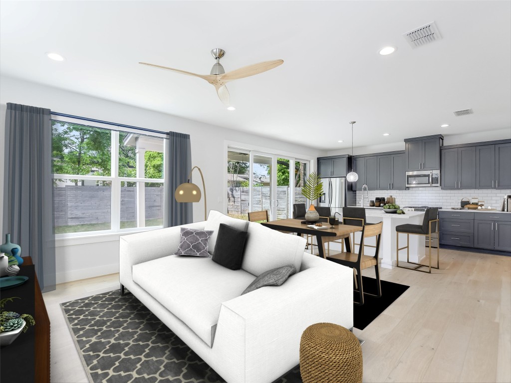 a bedroom with furniture and a large window