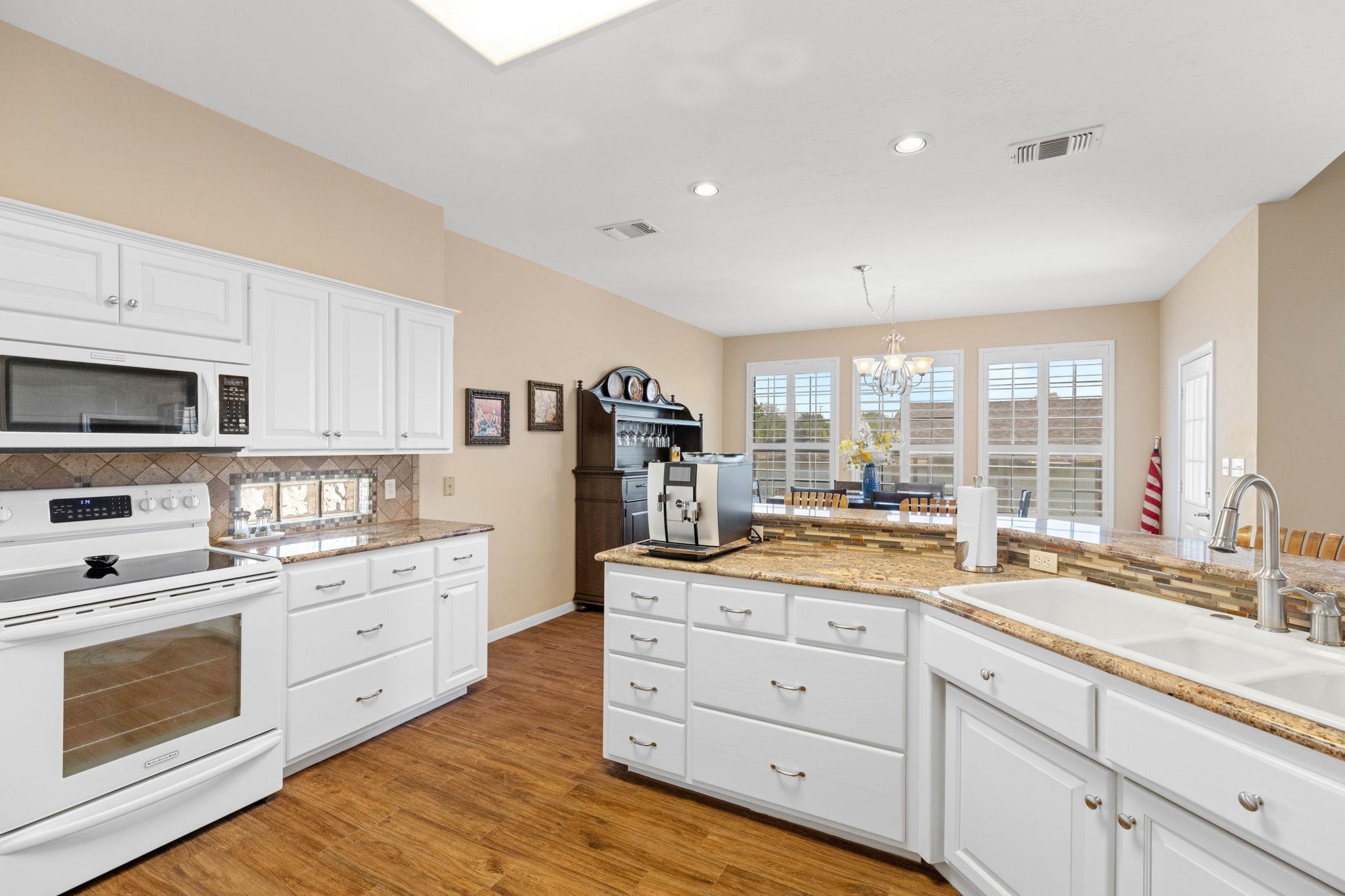 129 Web Isle Drive Granite Shoals, TX 78654 - Photo 17 of 30 a kitchen with granite countertop white cabinets white stainless steel appliances and sink