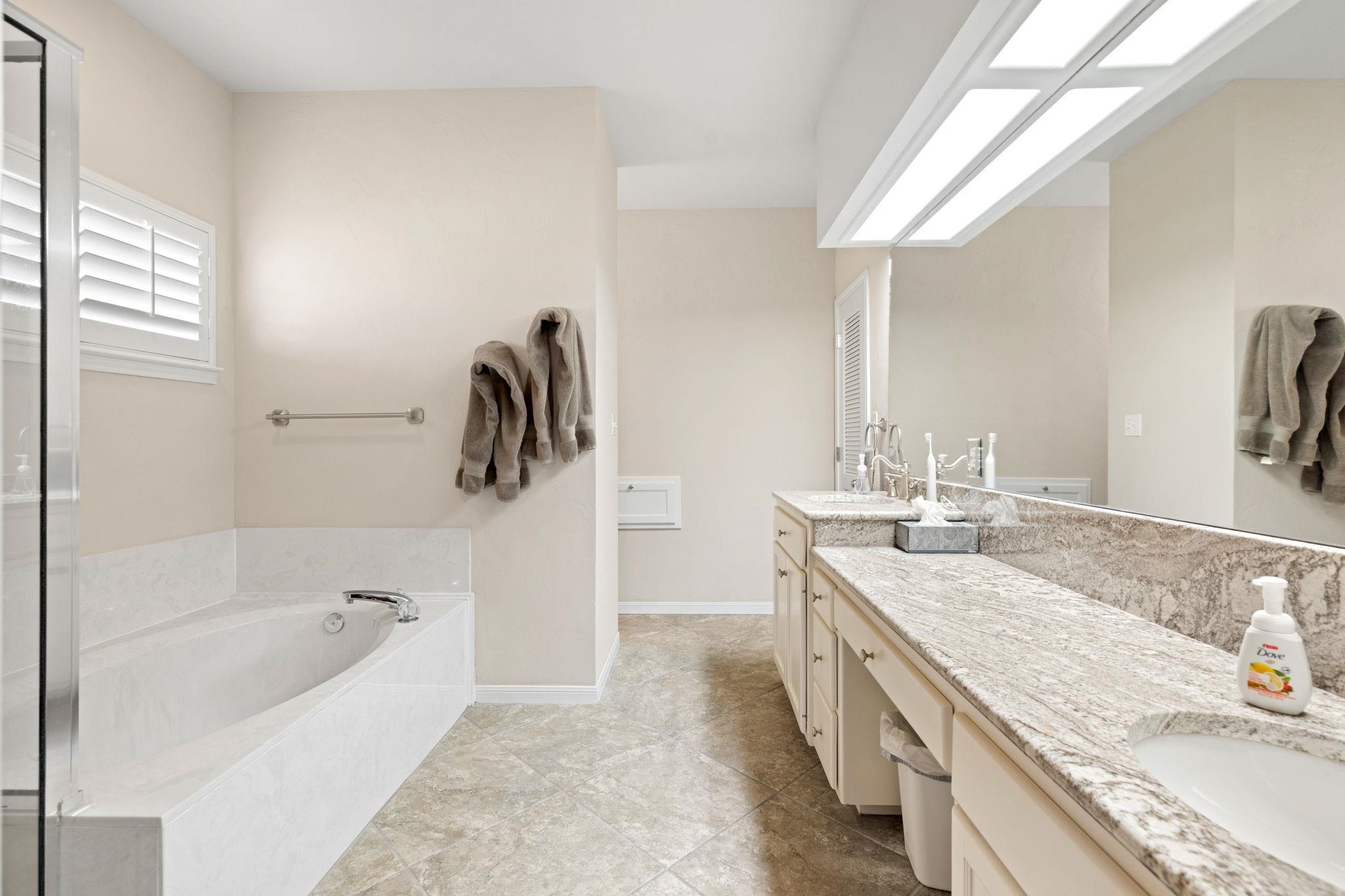 129 Web Isle Drive Granite Shoals, TX 78654 - Photo 20 of 30 a spacious bathroom with a granite countertop tub sink and mirror