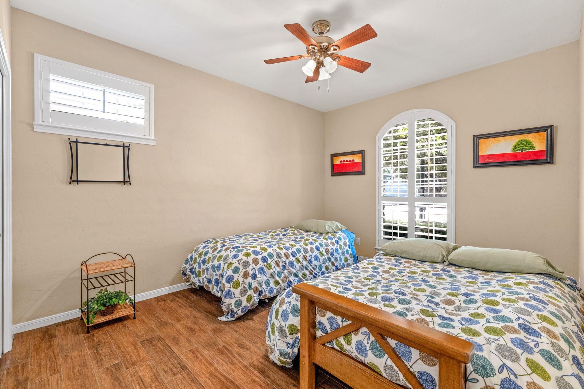 129 Web Isle Drive Granite Shoals, TX 78654 - Photo 25 of 30 a bedroom with a bed a dresser and paintings on the wall