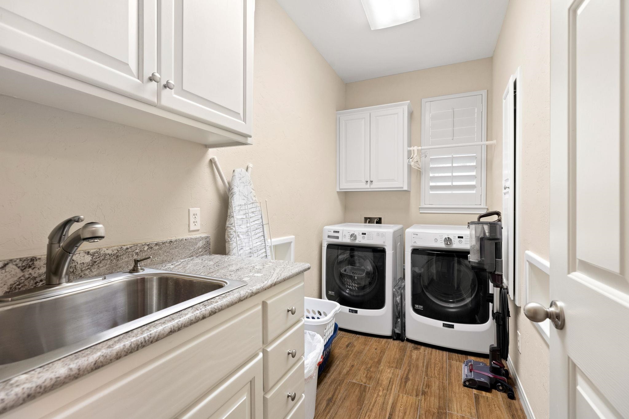 129 Web Isle Drive Granite Shoals, TX 78654 - Photo 27 of 30 a kitchen with a stove sink and cabinets