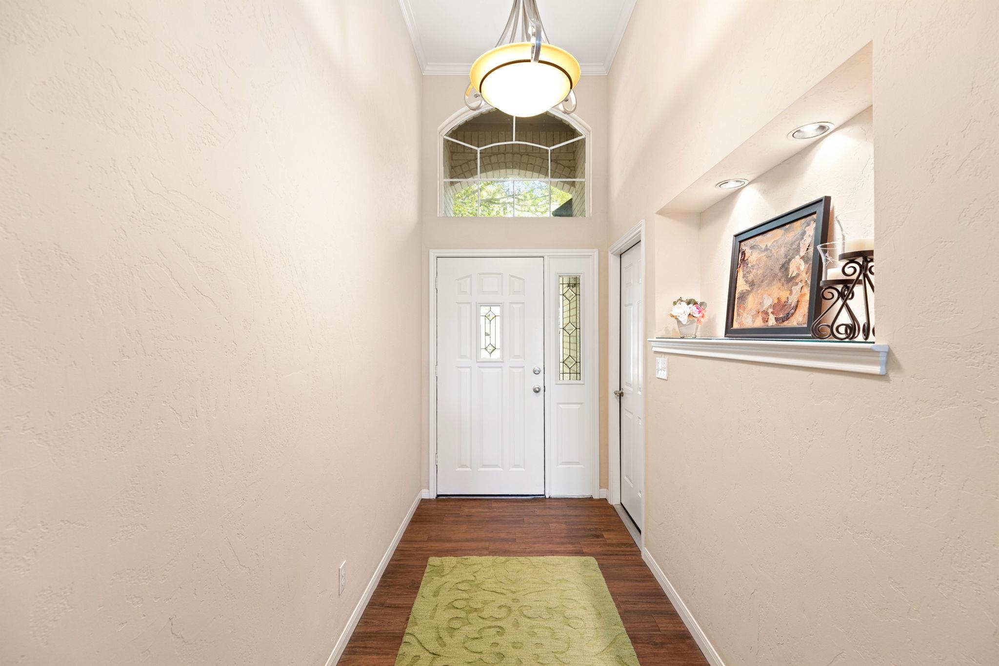 129 Web Isle Drive Granite Shoals, TX 78654 - Photo 7 of 30 a view of a hallway with wooden floor and a large window