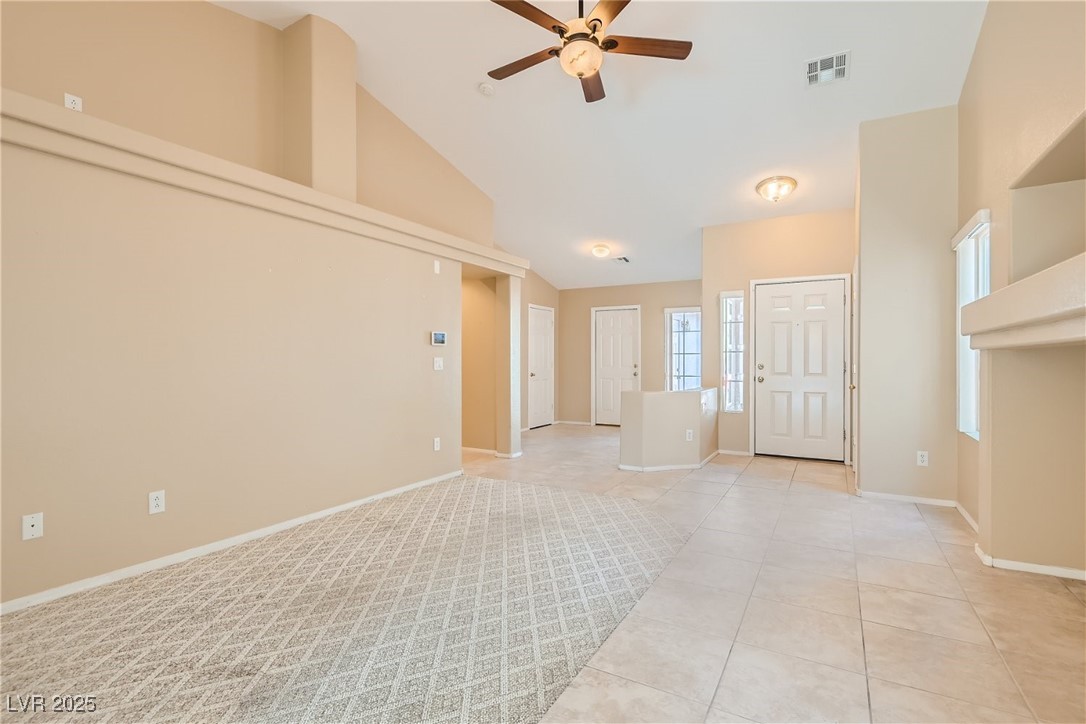 7550 Slipstream Street Las Vegas, NV 89139 - Photo 12 of 33 Unfurnished room with ceiling fan, light tile patterned floors, and high vaulted ceiling
