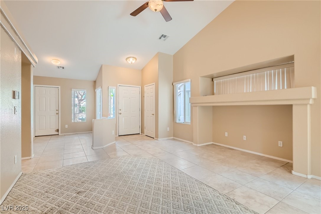 7550 Slipstream Street Las Vegas, NV 89139 - Photo 13 of 33 Entryway featuring light tile patterned floors, ceiling fan, and high vaulted ceiling