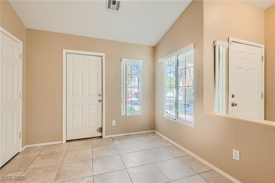 7550 Slipstream Street Las Vegas, NV 89139 - Photo 14 of 33 Foyer featuring light tile patterned floors and vaulted ceiling