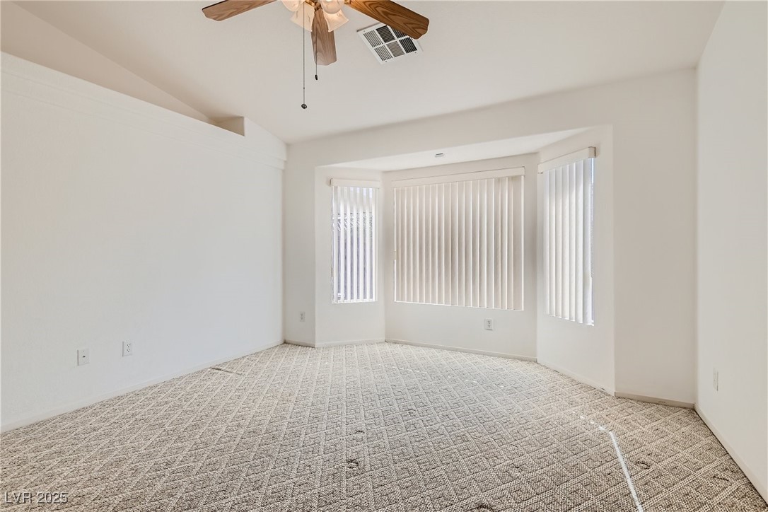 7550 Slipstream Street Las Vegas, NV 89139 - Photo 23 of 33 Spare room with carpet floors, lofted ceiling, and a ceiling fan
