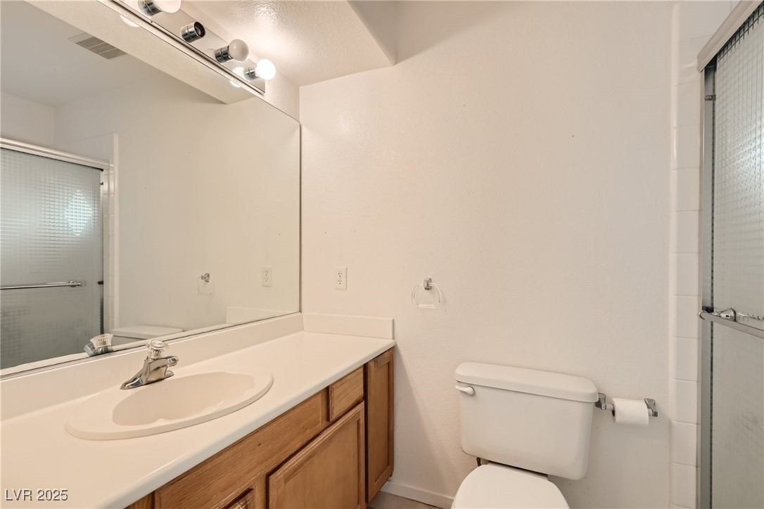 7550 Slipstream Street Las Vegas, NV 89139 - Photo 25 of 33 Full bath featuring a shower stall and vanity