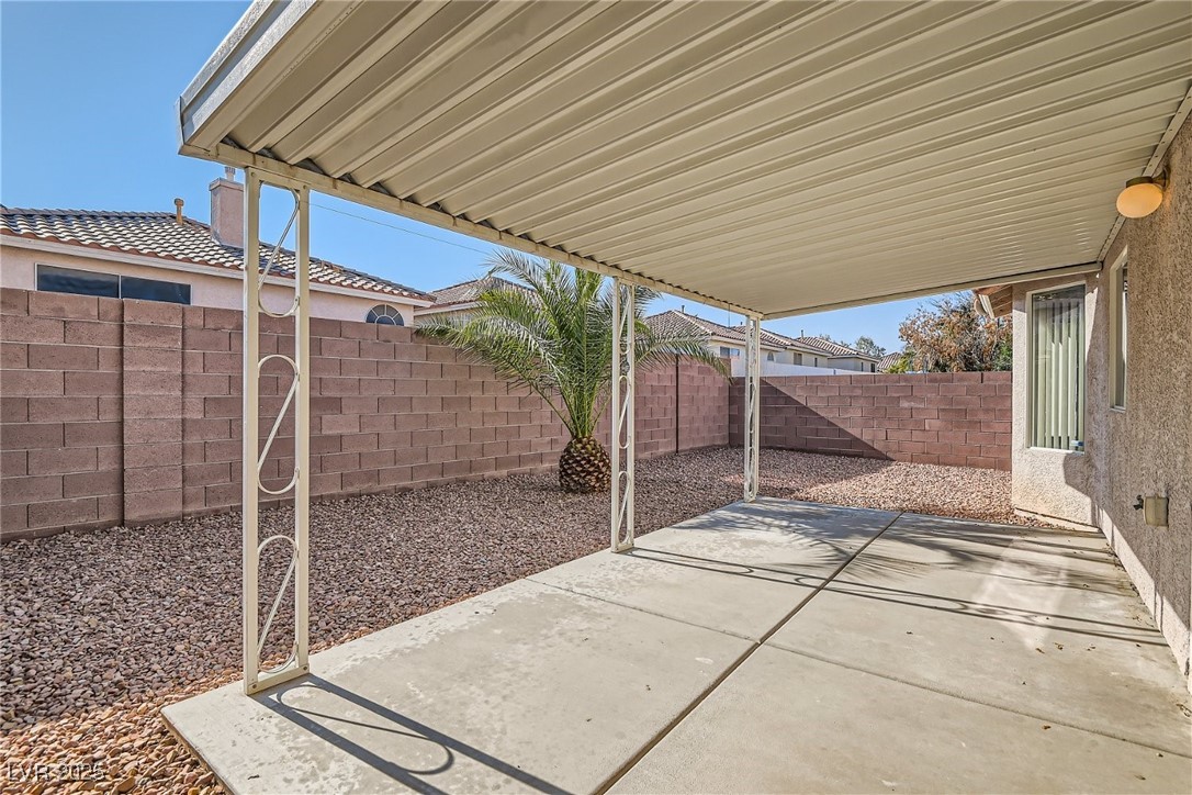 7550 Slipstream Street Las Vegas, NV 89139 - Photo 30 of 33 Fenced backyard with a patio