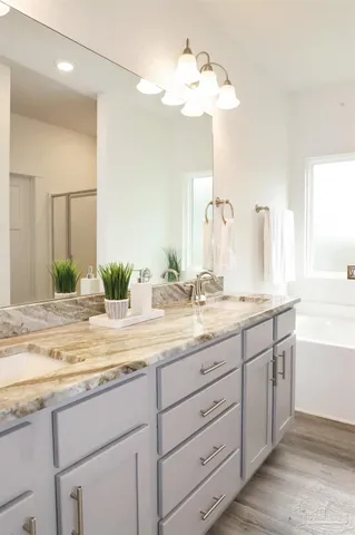 a bathroom with a double vanity sink and a mirror