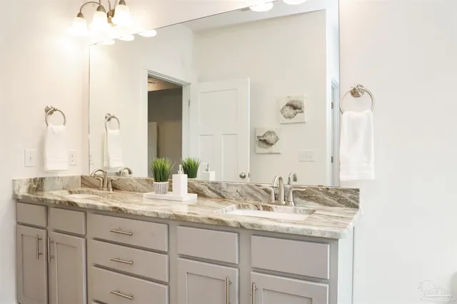 a bathroom with a double vanity sink and a mirror