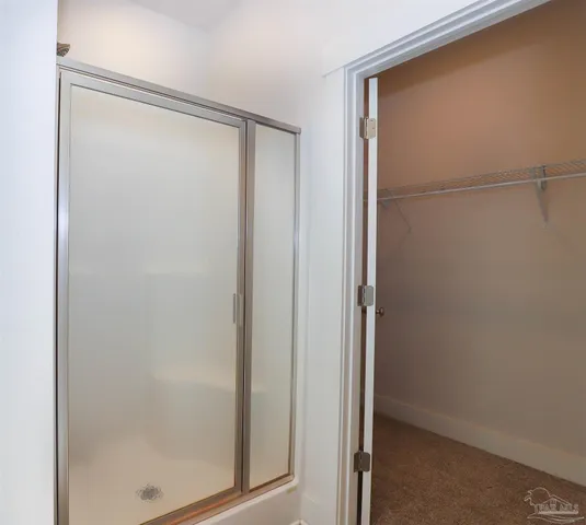 a bathroom with a glass shower door