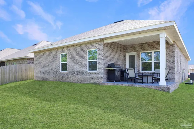 a view of a house with a yard and porch