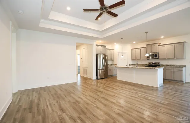a view of a kitchen with a sink and stainless steel appliances