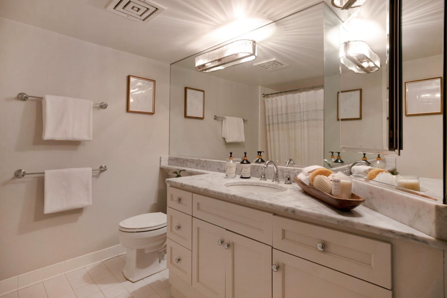 1483 Sutter Street, Unit 1101 San Francisco, CA 94109 - Photo 17 of 39 a bathroom with a toilet sink and mirror