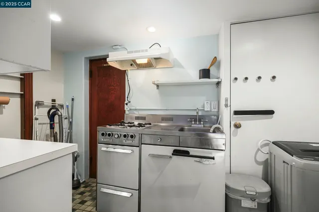 a kitchen with a sink and a stove top oven
