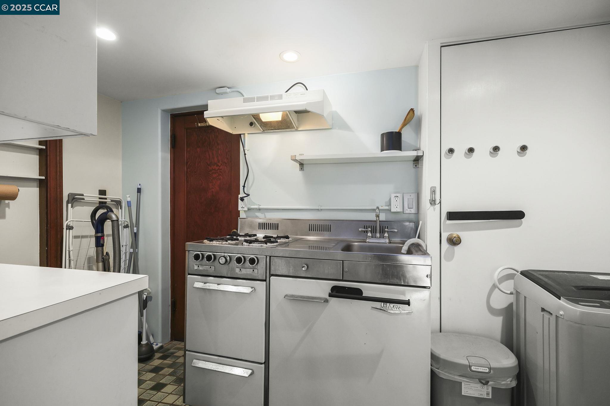1407 Euclid Avenue Berkeley, CA 94708 - Photo 11 of 16 a kitchen with a stove and a refrigerator