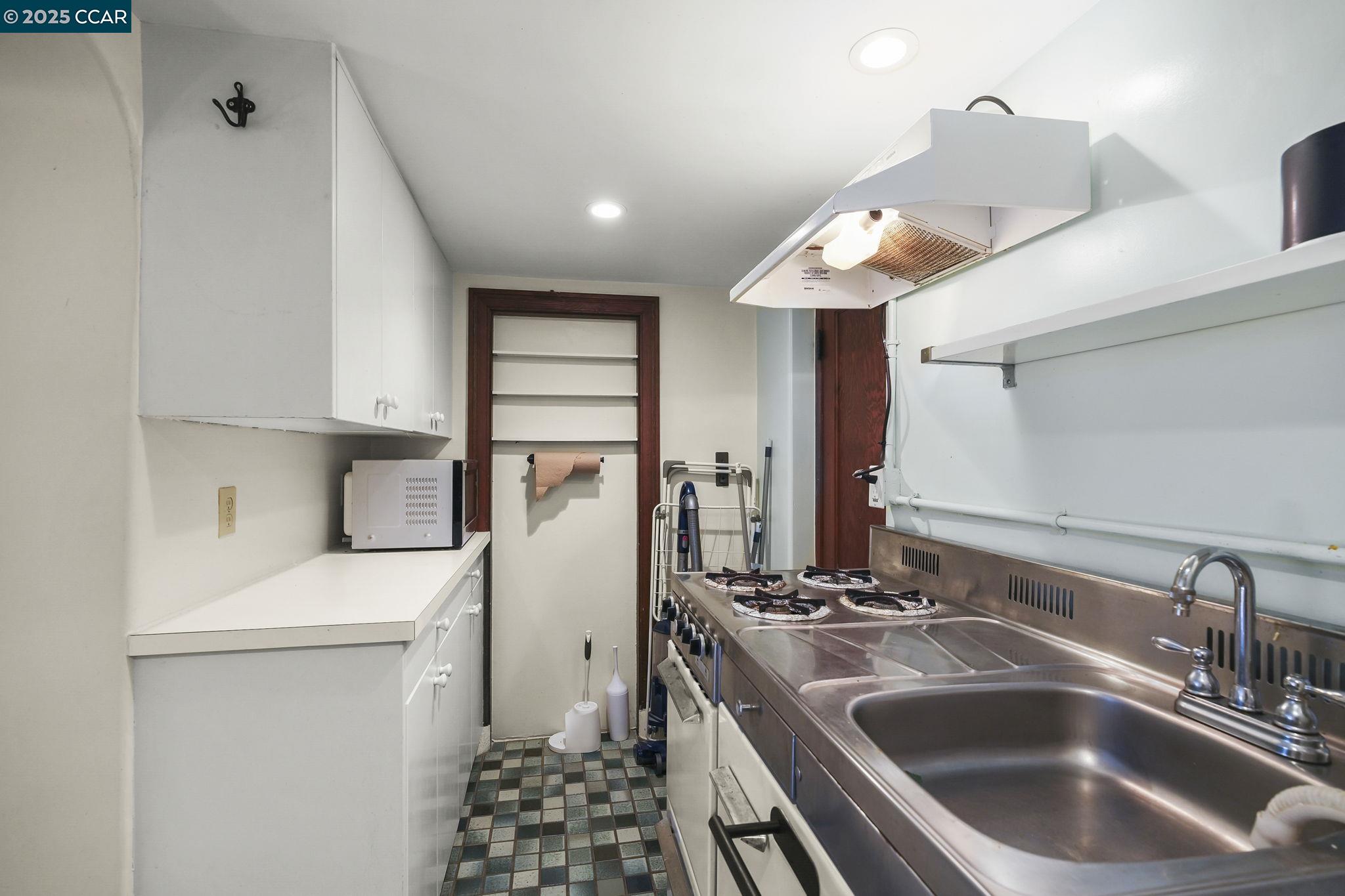 1407 Euclid Avenue Berkeley, CA 94708 - Photo 12 of 16 a kitchen with a sink and a stove top oven