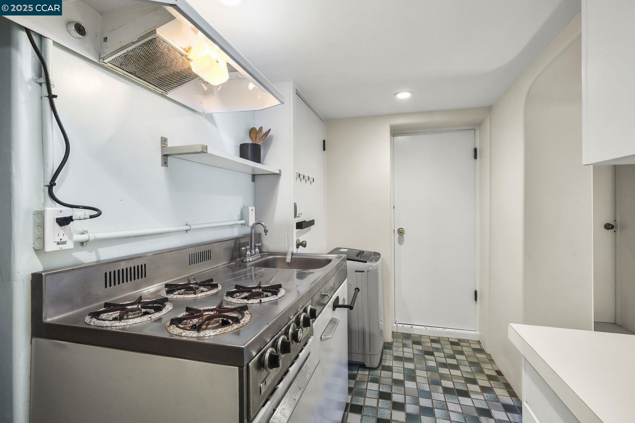 1407 Euclid Avenue Berkeley, CA 94708 - Photo 13 of 16 a kitchen with stainless steel appliances granite countertop a stove and a sink